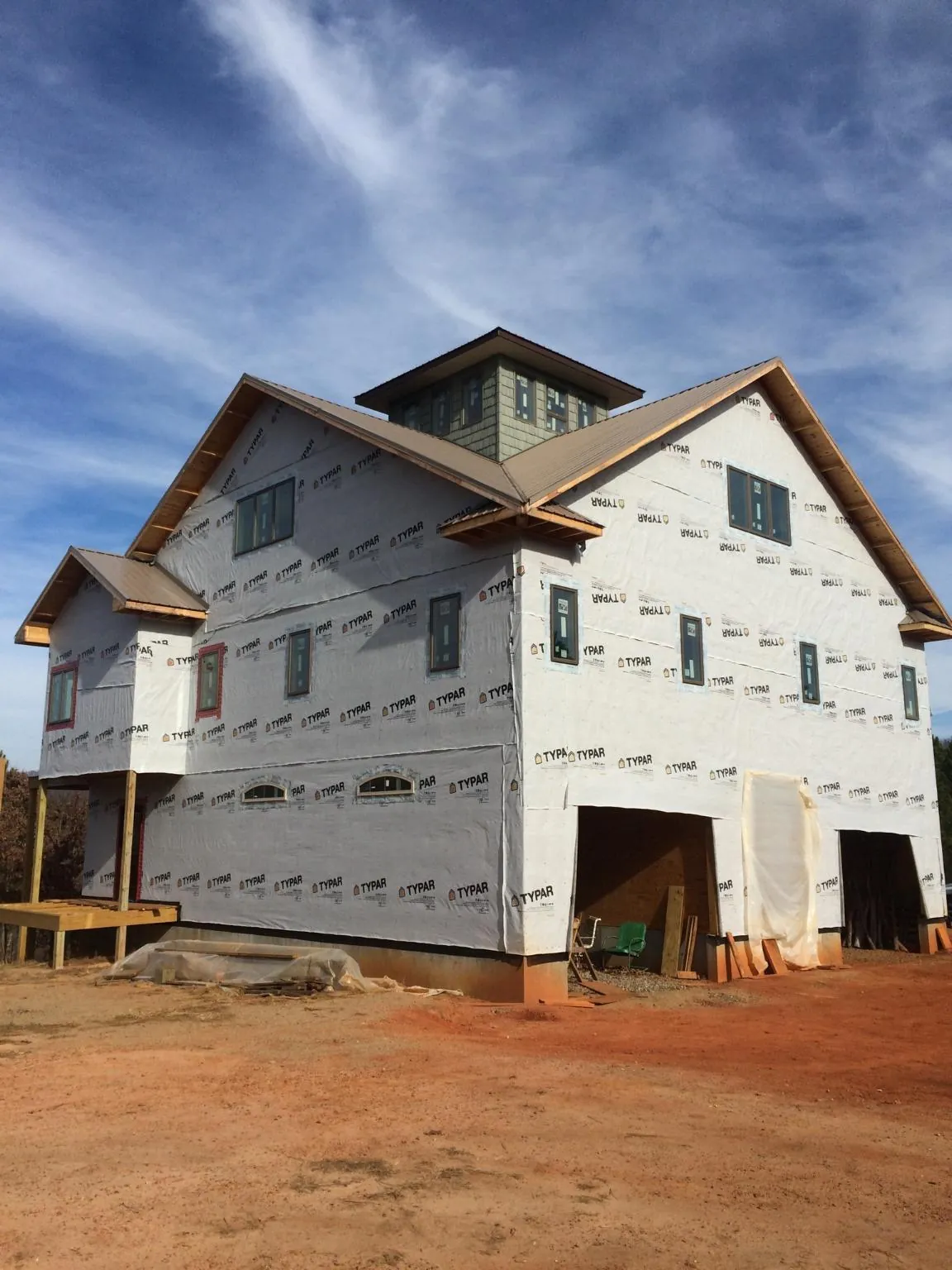 New two story house under construction with a cupola and gabled roofs in Sturtevant